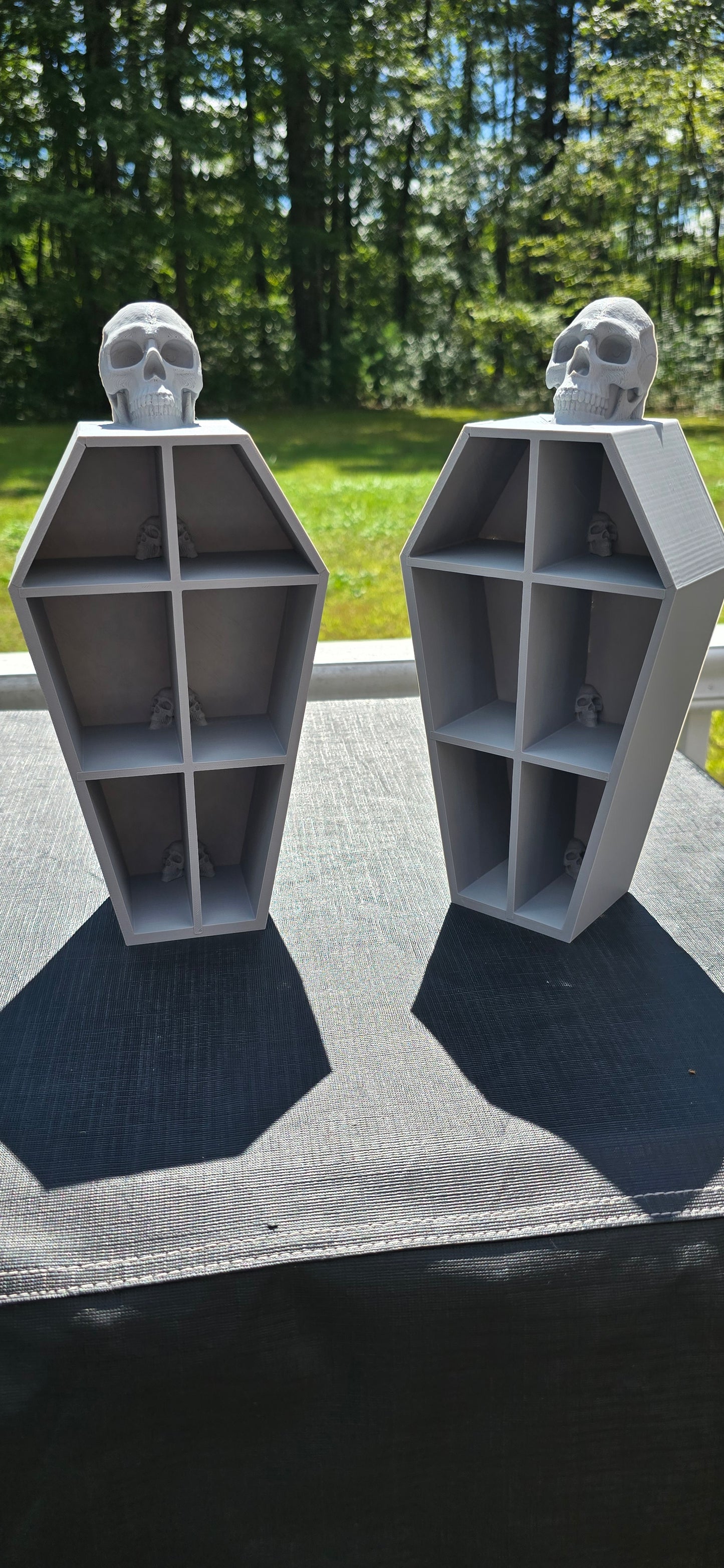 3D-Printed skull coffin shaped shelf.