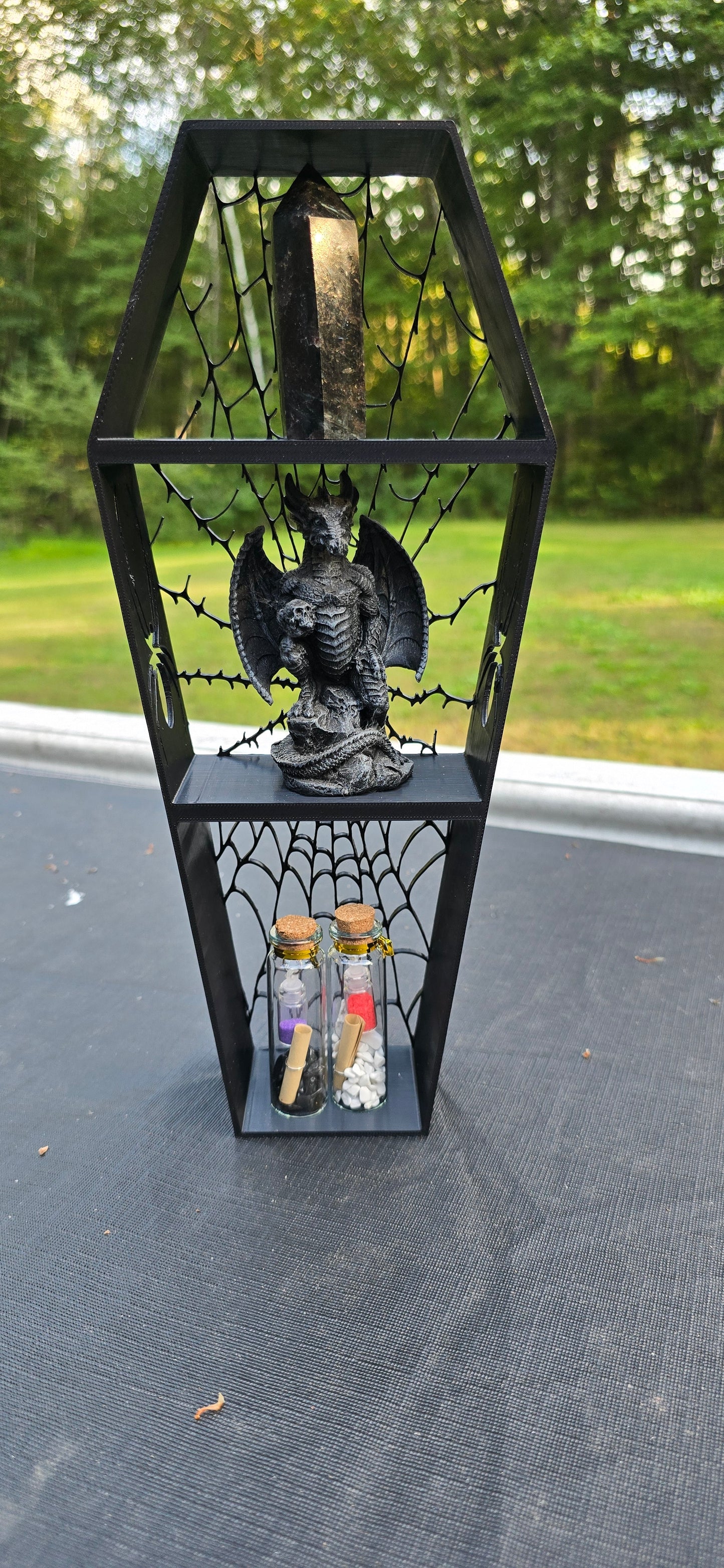 3D printed spiderweb Coffin shaped shelf.