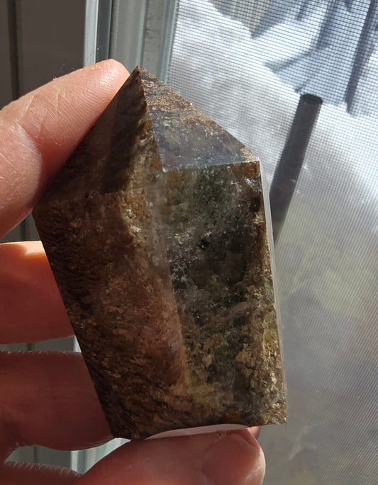 Thousand layer garden quartz tower with dense layered inclusions in clear lodolite quartz