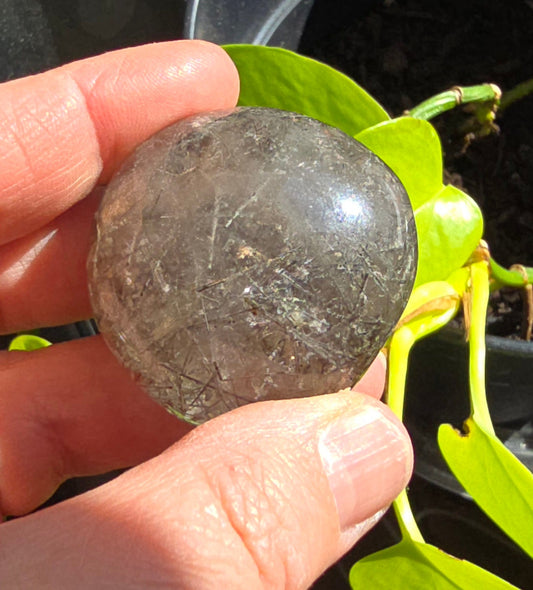 Silver rutilated and garden quartz lens from Brazil with silver needle inclusions and layered patterns in clear quartz