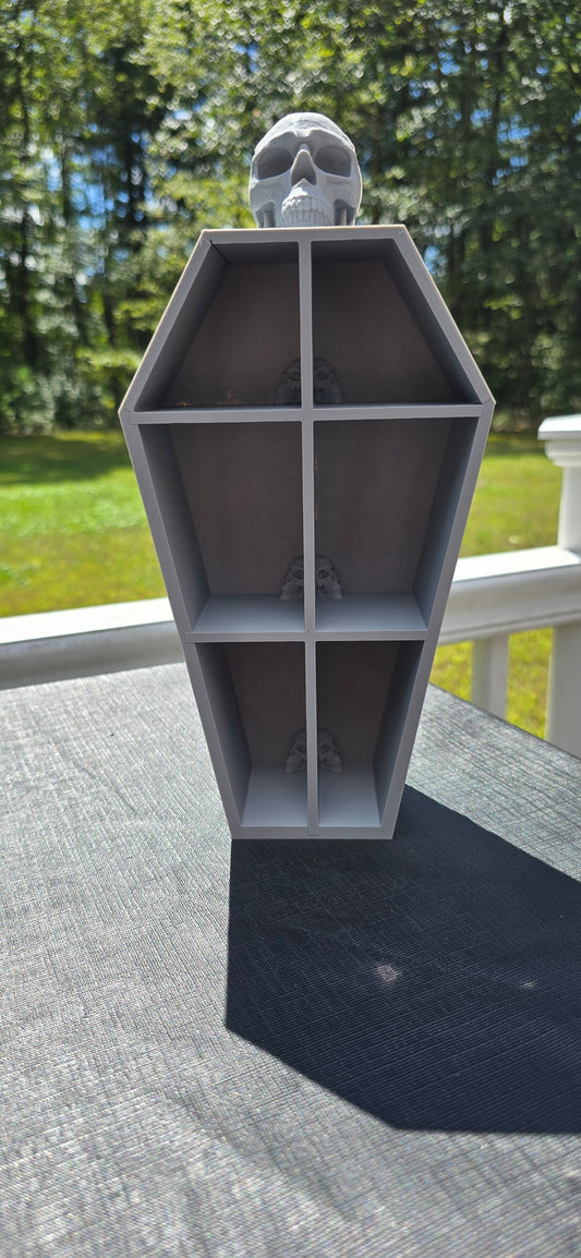 3D-Printed skull coffin shaped shelf.