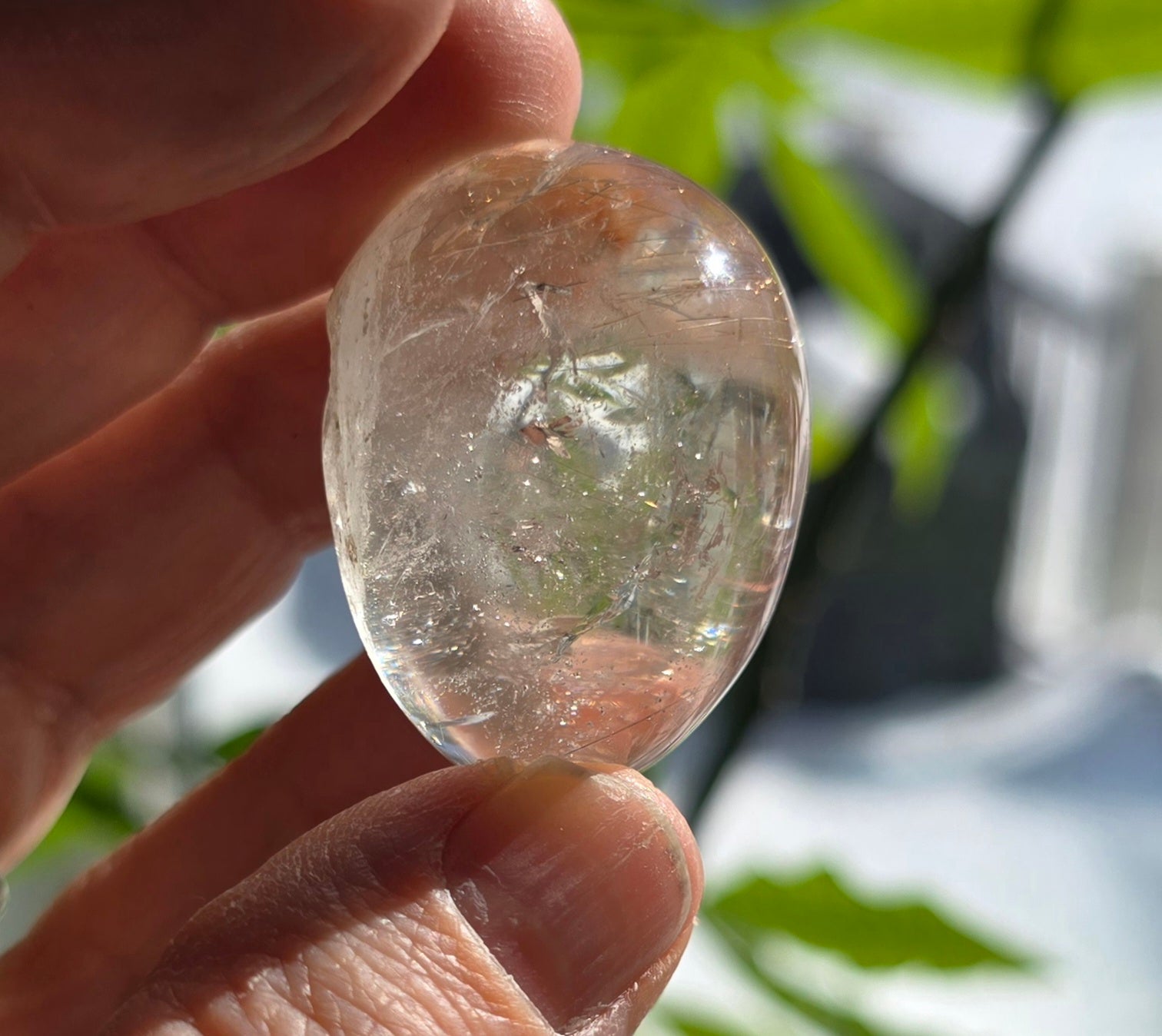 Gold Rutilated Quartz Lens illuminated by sunlight