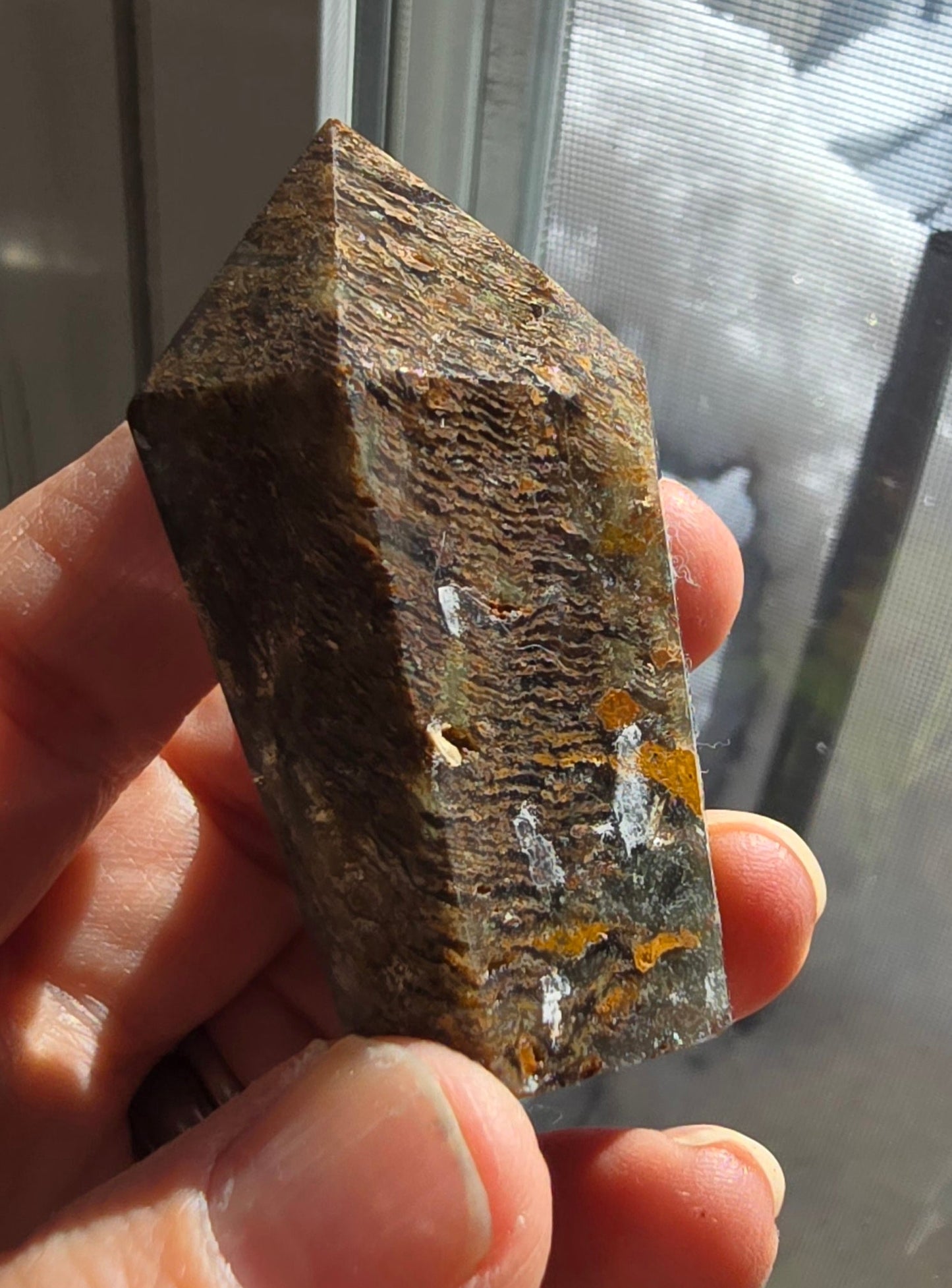 Thousand layer garden quartz tower with dense layered inclusions in clear lodolite quartz